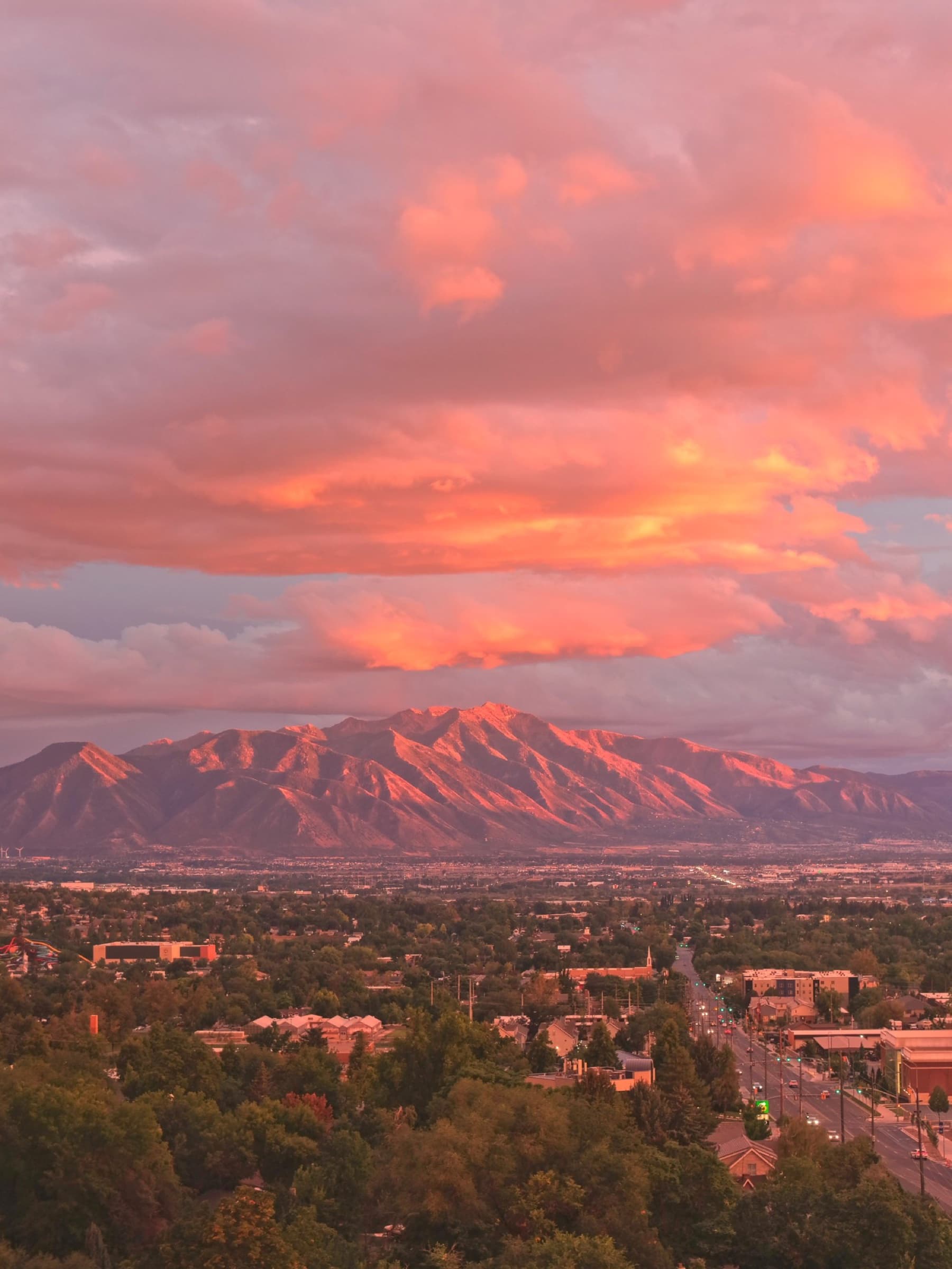Mount Timpanogos lit by sunset light under dramatic pink clouds, captured by Apex Visuals LLC