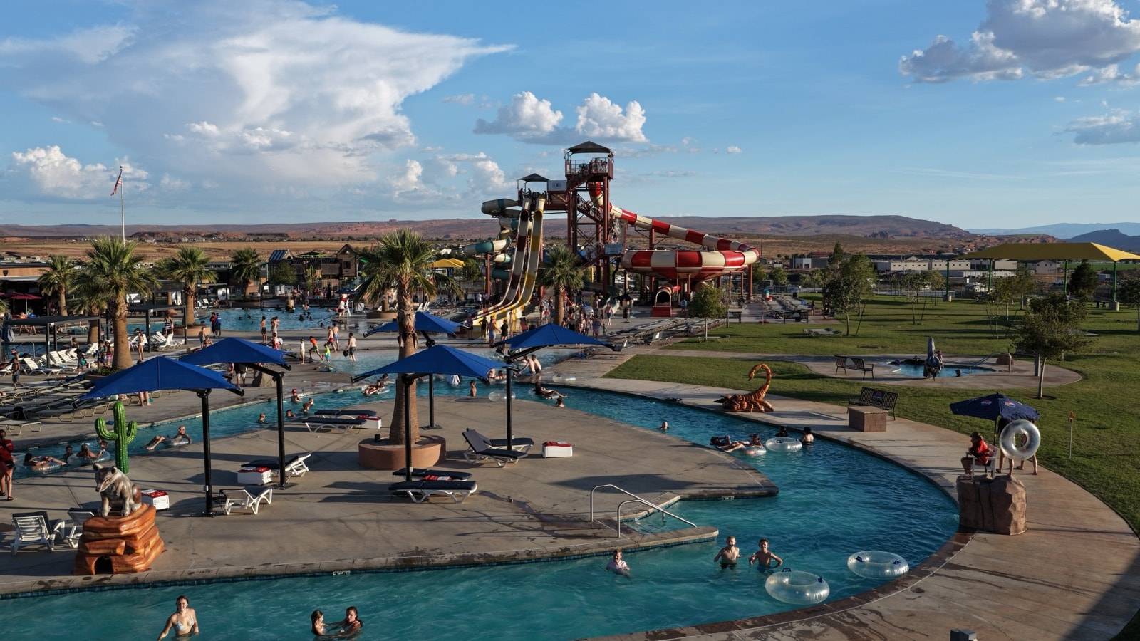 Wide aerial view of the Jellystone Zion water park: lazy river, shade structures and the slide tower under a summer sky