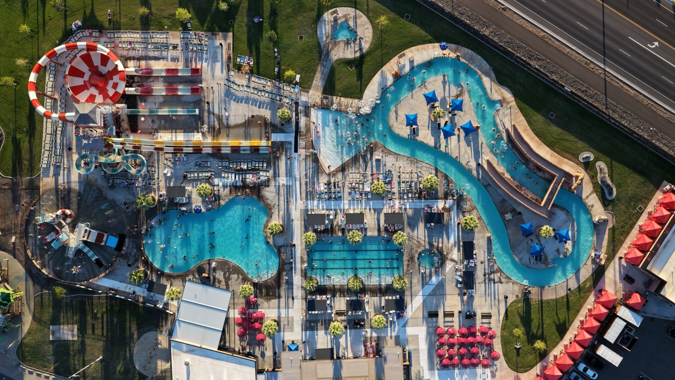 Top-down aerial of the Jellystone Zion water park, with the lazy river, pools and slide complex laid out like a site plan